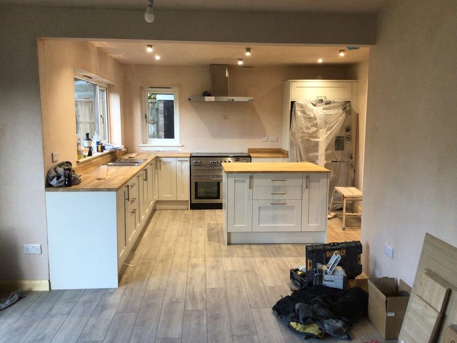 Kitchen mid-fit with oak worktops and wall units installed